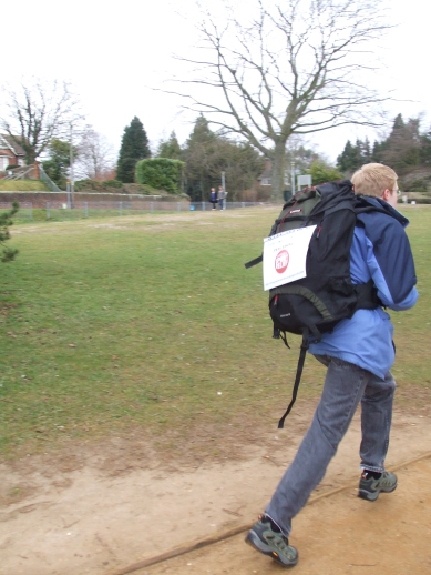 Adam running almost faster than the camera, with backpack in tow