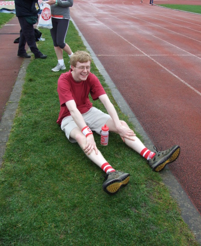 Sitting down with a water bottle trying to stretch my legs